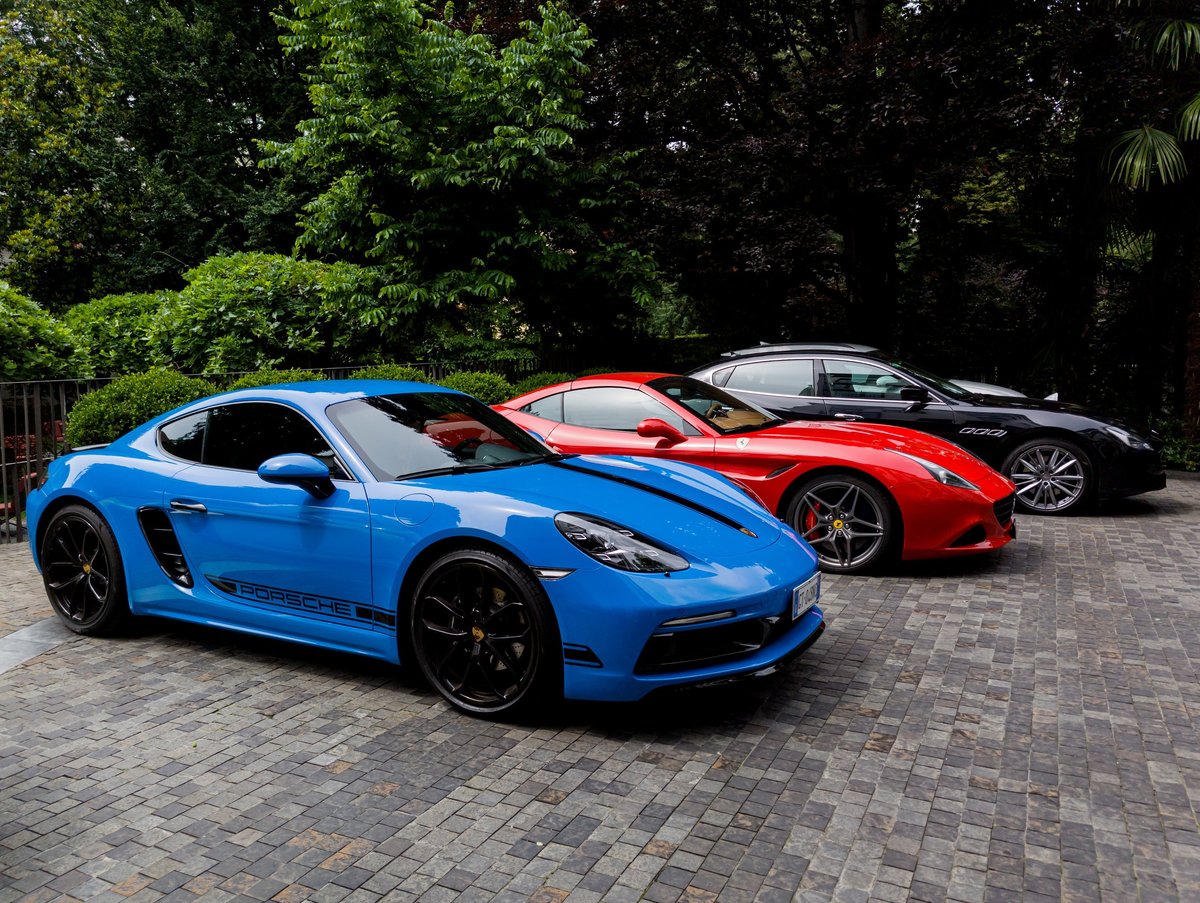 Milan, Italy, June 18, 2024 - Side view of a blue porsche parked outside
